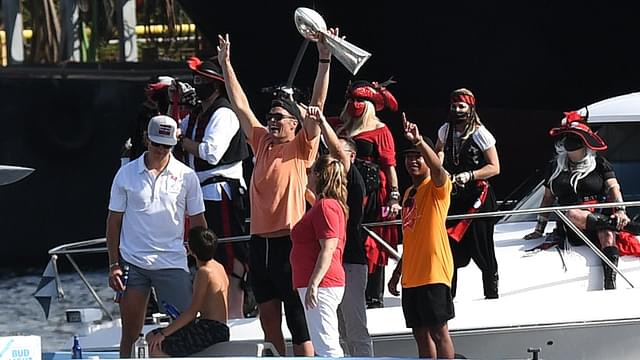 Tampa Bay Buccaneers quarterback Tom Brady celebrates with the Vince Lombardi Trophy on his boat during the Tampa Bay Buccaneers boat parade to celebrate their victory over the Kansas City Chiefs in Super Bowl LV.