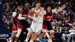 Washington Wizards forward Richaun Holmes (22) and forward Kyshawn George (18) defend on Denver Nuggets center Nikola Jokic (15) in the second half at Ball Arena