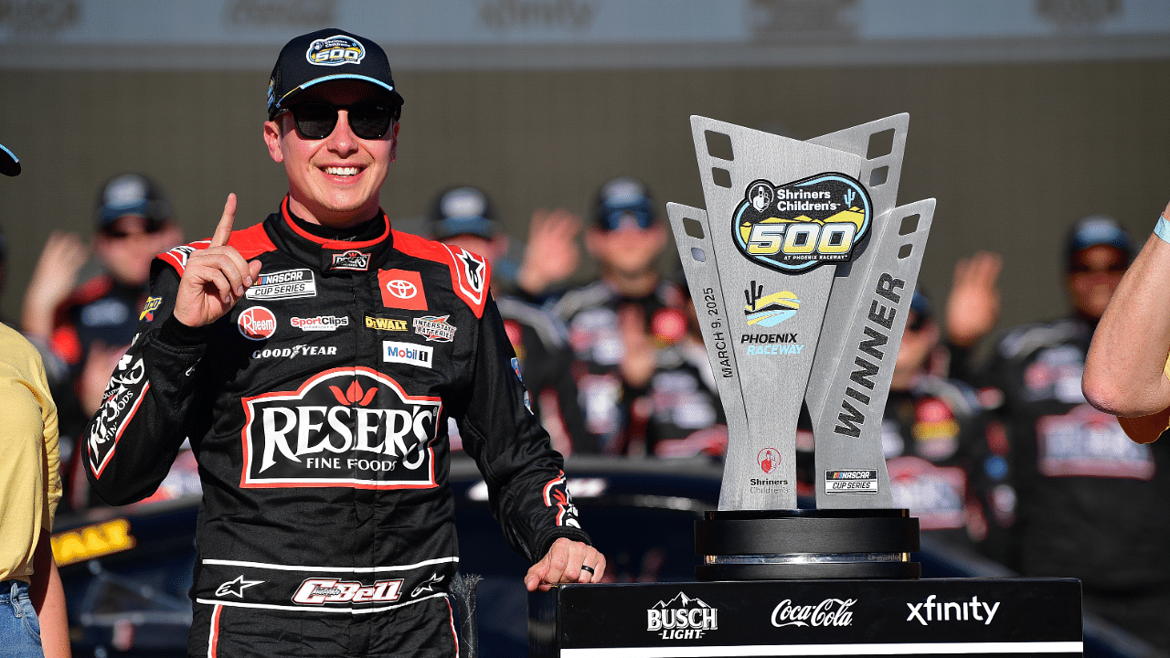 Mar 9, 2025; Avondale, Arizona, USA; NASCAR Cup Series driver Christopher Bell (20) celebrates his victory of the Shriners Children’s 500 at Phoenix Raceway. Mandatory Credit: Gary A. Vasquez-Imagn Images