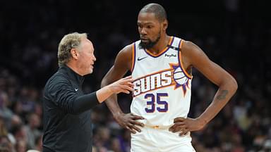 Phoenix Suns head coach Mike Budenholzer talks with Phoenix Suns forward Kevin Durant (35) against the Denver Nuggets during the second half at Footprint Center