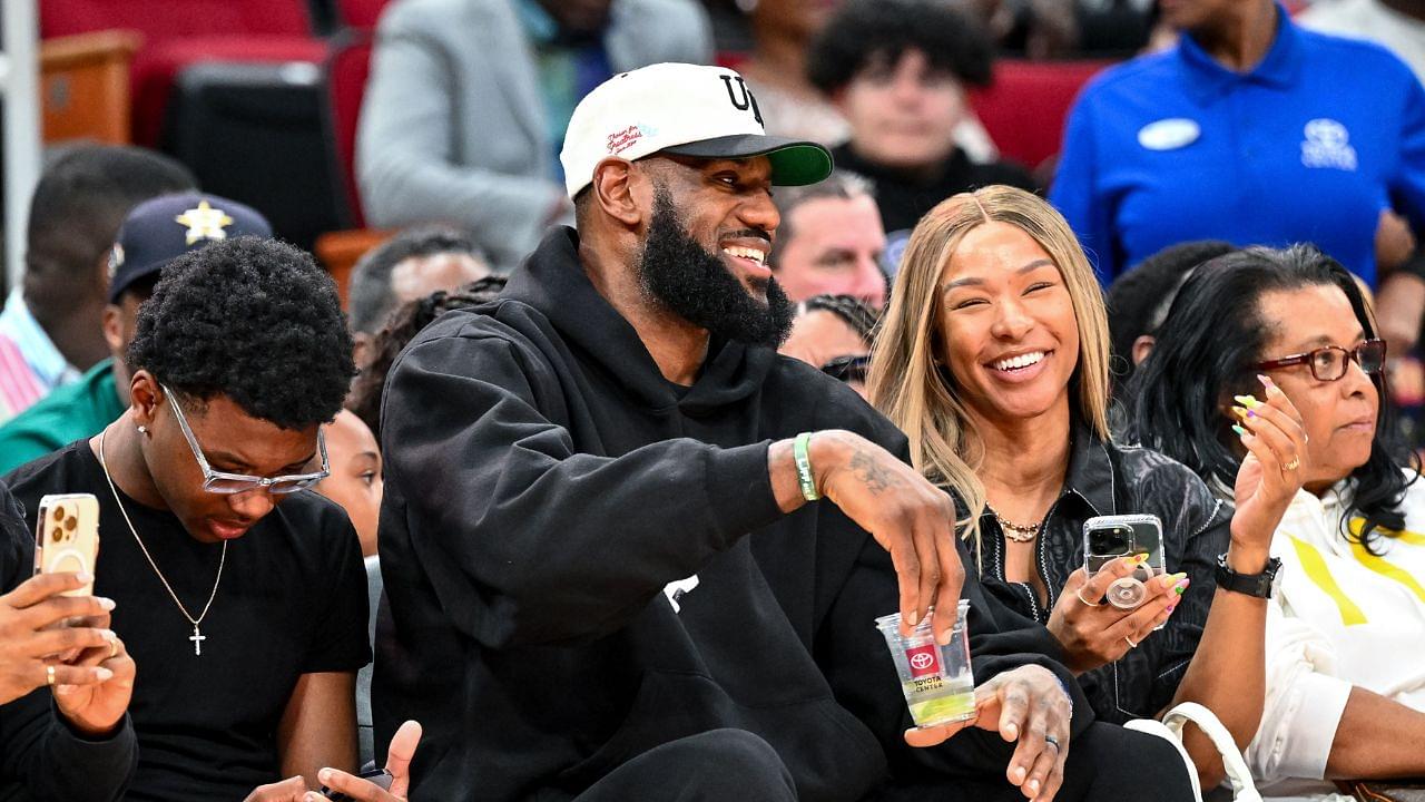 Los Angeles Laker LeBron James and his wife Savannah James sit court side at the McDonald's All American game during the first half at Toyota Center.