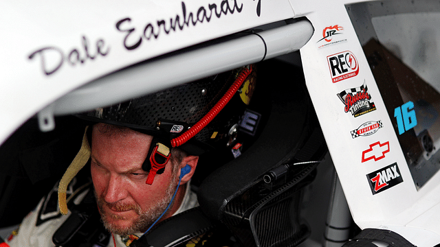 Jul 20, 2024; Hampton, VA, USA; Dale Earnhardt Jr. waits in his car during qualifying for the 16th Annual Hampton Heat at Langley Speedway. Mandatory Credit: Peter Casey-Imagn Images