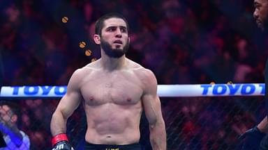 Islam Makhachev (red gloves) reacts after defeating Renato Moicano (blue gloves) in a lightweight title fight during UFC 311 at Intuit Dome.