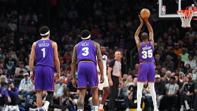 Phoenix Suns guard Devin Booker (1) and Phoenix Suns guard Bradley Beal (3) watch as Phoenix Suns forward Kevin Durant (35) shoots a free throw against the Minnesota Timberwolves during the first half at Footprint Center.