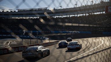 NASCAR Cup Series drivers race into turn three during the NASCAR Cup Series Championship race at Phoenix Raceway.