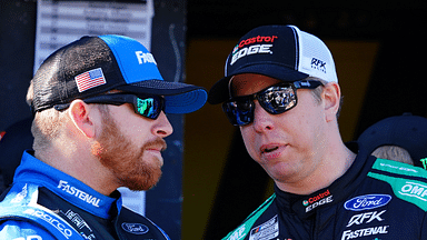 NASCAR Cup Series driver Brad Keselowski (6) and driver Chris Buescher (17) talk during driver introductions before the Daytona 500 at Daytona International Speedway.