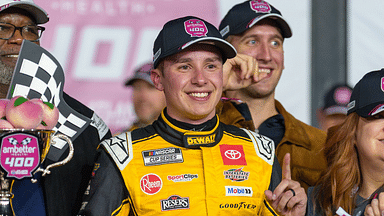 Christopher Bell (20) poses with his trophy in Victory Lane after claiming a victory at Atlanta Motor Speedway.