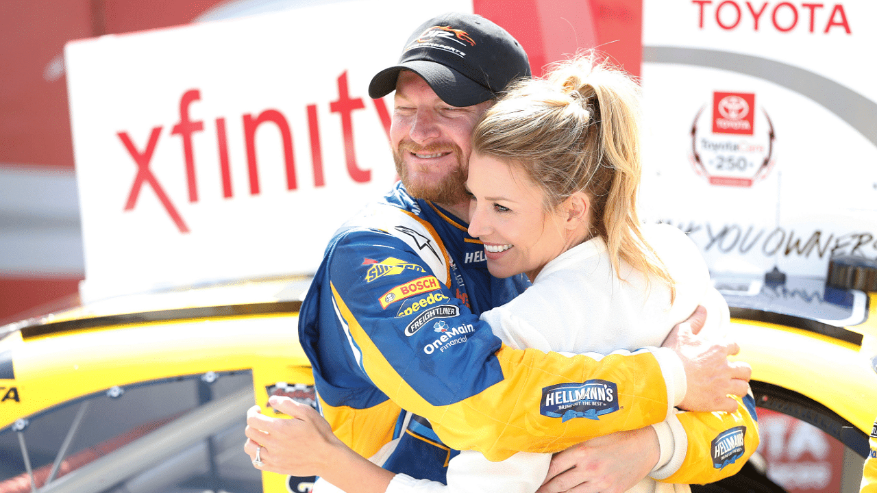 Apr 23, 2016; Richmond, VA, USA; Xfinity Series driver Dale Earnhardt Jr. (88) celebrates with his fianc Amy Reimann in Victory Lane after winning the Toyotacare 250 at Richmond International Raceway. Mandatory Credit: Amber Searls-Imagn Images