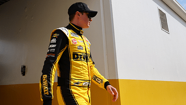 Feb 16, 2025; Daytona Beach, Florida, USA; NASCAR Cup Series driver Christopher Bell (20) walks to the drivers meeting before the Daytona 500 at Daytona International Speedway. Mandatory Credit: Peter Casey-Imagn Images