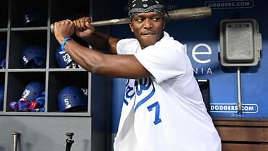 British YouTuber KSI and cruiserweight professional boxer swings a bat in the dugout prior to the game between the Los Angeles Dodgers and the Arizona Diamondbacks at Dodger Stadium.