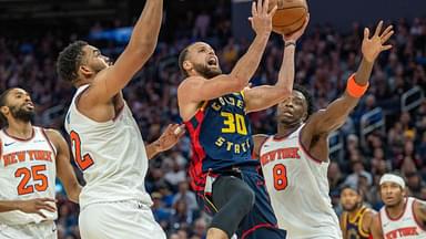 Golden State Warriors guard Stephen Curry (30) shoots a layup against New York Knicks center Karl-Anthony Towns (32) during the fourth quarter at Chase Center