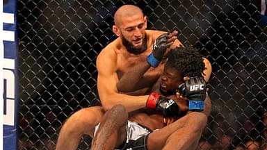 Khamzat Chimaev (red gloves) fights Kevin Holland (blue gloves) during UFC 279 at T-Mobile Arena.