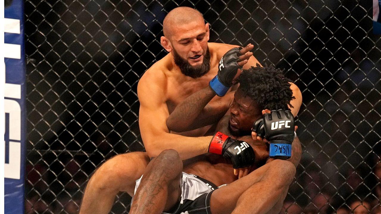 Khamzat Chimaev (red gloves) fights Kevin Holland (blue gloves) during UFC 279 at T-Mobile Arena.