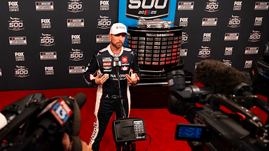 Feb 12, 2025; Daytona Beach, Florida, USA; NASCAR Cup Series driver Denny Hamlin during Daytona 500 media day at Daytona International Speedway. Mandatory Credit: Mark J. Rebilas-Imagn Images