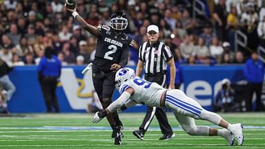 Colorado Buffaloes quarterback Shedeur Sanders (2) attempts a pass as Brigham Young Cougars defensive end Tyler Batty (92) attempts to make a tackle during the third quarter at Alamodome.