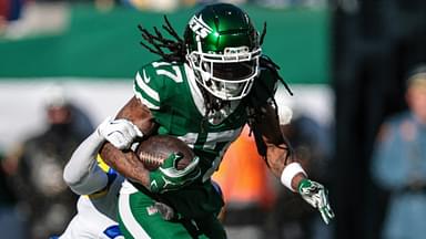 Dec 22, 2024; East Rutherford, New Jersey, USA; New York Jets wide receiver Davante Adams (17) fights for yards as Los Angeles Rams safety Quentin Lake (37) tackles during the first half at MetLife Stadium.