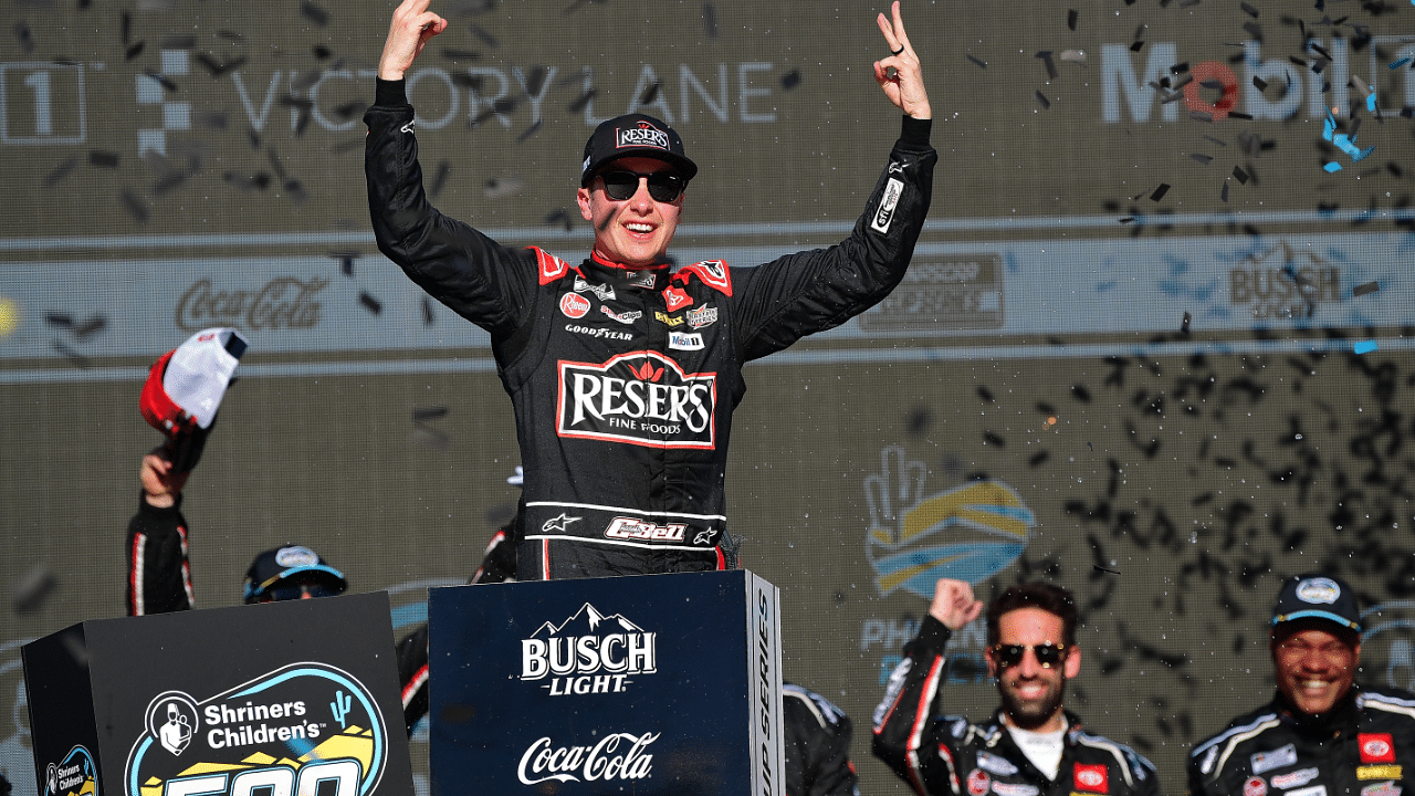 Mar 9, 2025; Avondale, Arizona, USA; NASCAR Cup Series driver Christopher Bell (20) celebrates his victory of the Shriners Children’s 500 at Phoenix Raceway. Mandatory Credit: Gary A. Vasquez-Imagn Images