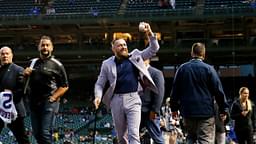 MMA fighter Conor McGregor waves to fans as he walks off the field before the game between the Chicago Cubs and the Minnesota Twins at Wrigley Field.