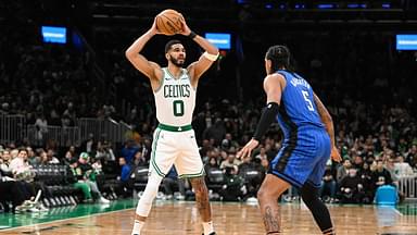Boston Celtics forward Jayson Tatum (0) looks to pass the ball over Orlando Magic forward Paolo Banchero (5) during the second half at TD Garden.