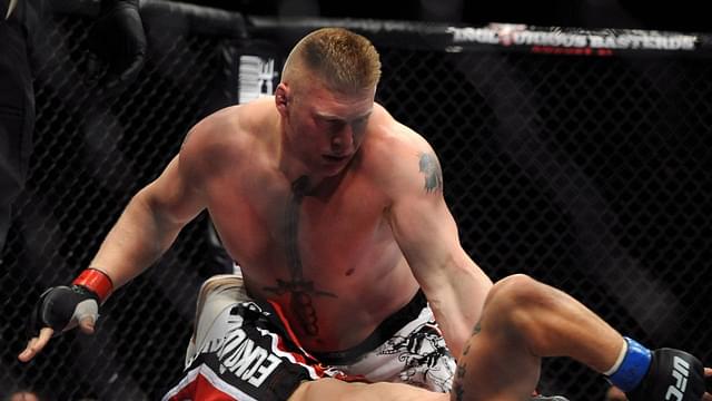 Brock Lesnar (top) of the USA holds down Frank Mir of the USA