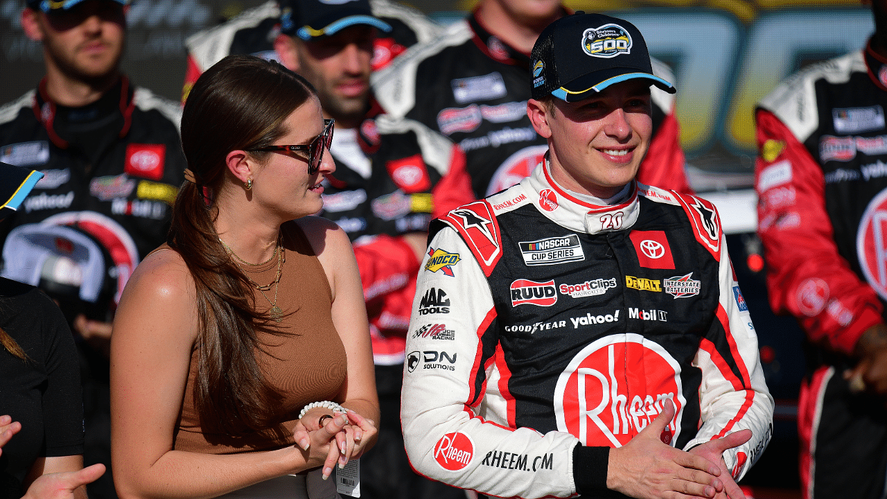 Mar 10, 2024; Avondale, Arizona, USA; NASCAR Cup Series driver Christopher Bell (20) celebrates his victory of the Shriners Childrens 500 with wife Morgan Bell at Phoenix Raceway. Mandatory Credit: Gary A. Vasquez-Imagn Images