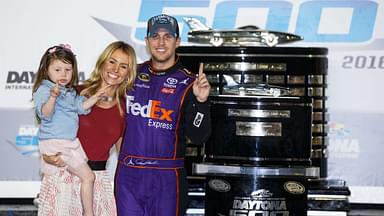 NASCAR Sprint Cup Series driver Denny Hamlin (11) poses with the Harley J. Earl Trophy with his girls Jordan Fish and his daughter Taylor James Hamlin after winning the Daytona 500 at Daytona International Speedway.