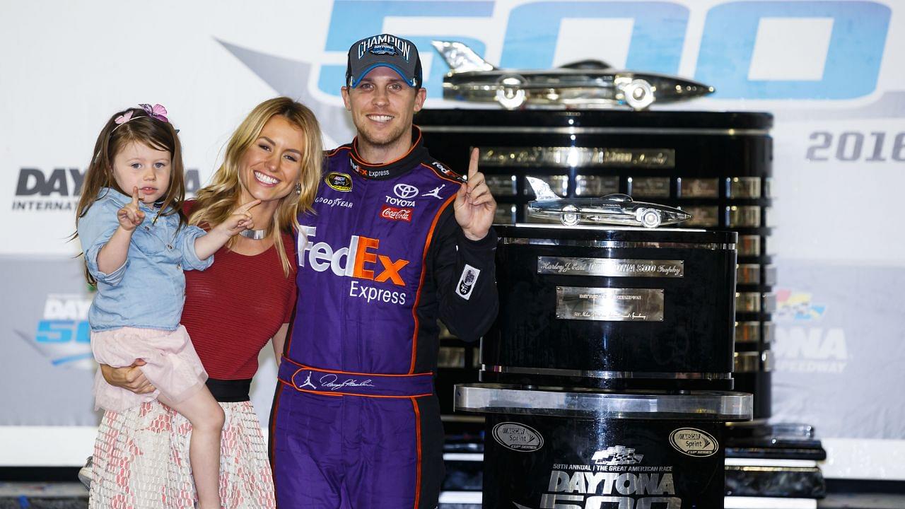 NASCAR Sprint Cup Series driver Denny Hamlin (11) poses with the Harley J. Earl Trophy with his girls Jordan Fish and his daughter Taylor James Hamlin after winning the Daytona 500 at Daytona International Speedway.