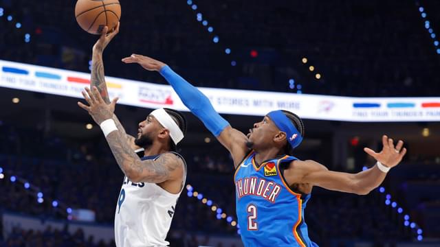 May 22, 2025; Oklahoma City, Oklahoma, USA; Minnesota Timberwolves guard Nickeil Alexander-Walker (9) shoots against Oklahoma City Thunder guard Shai Gilgeous-Alexander (2) in the third quarter during game two of the western conference finals for the 2025 NBA Playoffs at Paycom Center
