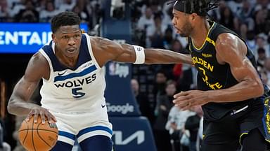 Minnesota Timberwolves guard Anthony Edwards (5) dribbles around Golden State Warriors forward Buddy Hield (7) in the first quarter during game one of the second round for the 2025 NBA Playoffs at Target Center.