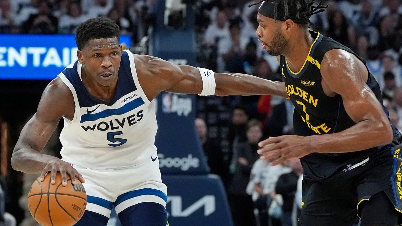Minnesota Timberwolves guard Anthony Edwards (5) dribbles around Golden State Warriors forward Buddy Hield (7) in the first quarter during game one of the second round for the 2025 NBA Playoffs at Target Center.