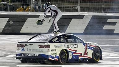 NASCAR Cup Series driver Ross Chastain (1) celebrates his come from behind win with a burnout and tossing a watermelon on the finish line during the Coca Cola 600 at Charlotte Motor Speedway.