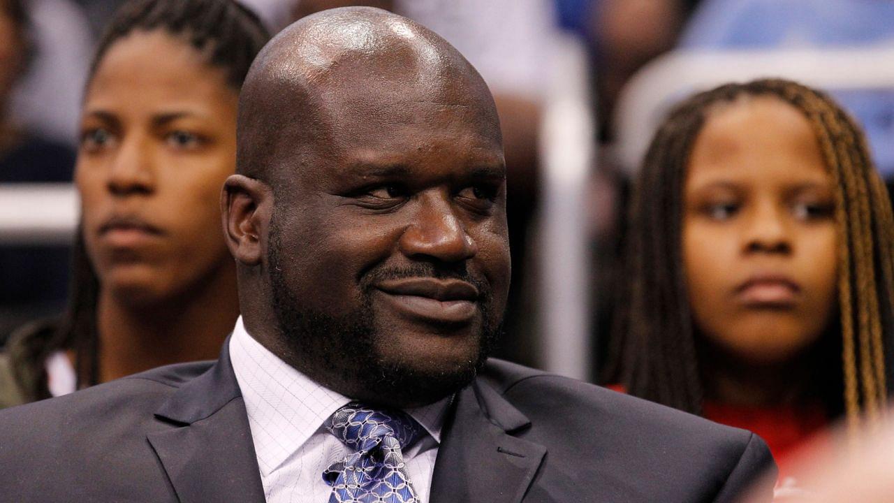 Former NBA player Shaquille O'Neal sits with his family as he watches the game as he was inducted into the Magic Hall of Fame during the first half against the Detroit Pistons at Amway Center.