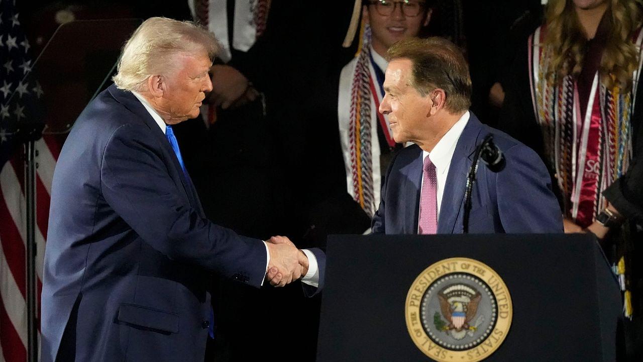 President Donald Trump shakes hands with legendary Alabama football coach Nick Saban before delivering a special commencement address to University of Alabama graduates at Coleman Coliseum. Graduation occurs over the weekend.