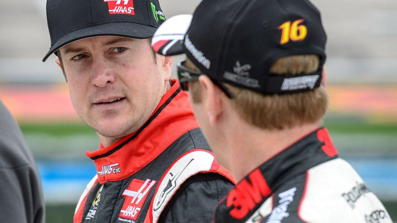 Former Sprint Cup Series driver Kurt Busch (41) talks with driver Greg Biffle (16) during qualifying for the Duck Commander 500 at Texas Motor Speedway.