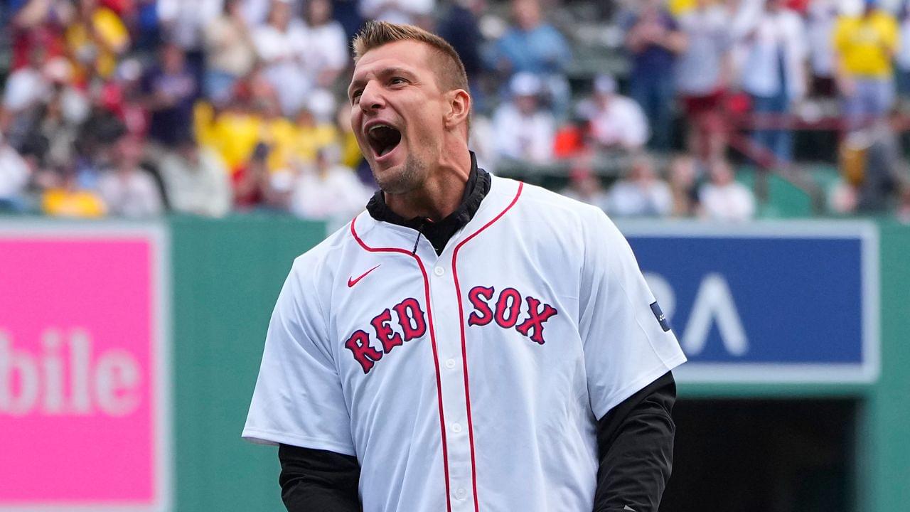 Former NFL player Rob Gronkowski reacts to throwing out a ceremonial first pitch prior to the game between the Cleveland Guardians and Boston Red Sox at Fenway Park.