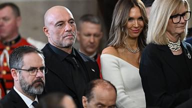 US media personality Joe Rogan stands for a benediction after President Donald Trump was sworn in as the 47th US President in the US Capitol Rotunda in Washington