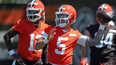 Cleveland Browns quarterback Dillon Gabriel (5) throws as quarterback Shedeur Sanders (12) looks on during NFL rookie minicamp at the Cleveland Browns training facility on Friday, May 9, 2025, in Berea, Ohio.