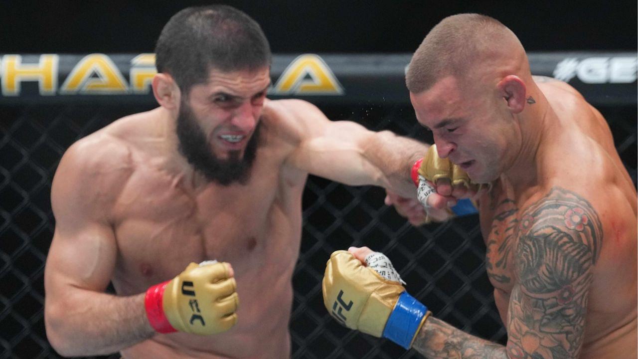 Islam Makhachev (red gloves) fights Dustin Poirier (blue gloves) during UFC 302 at Prudential Center.