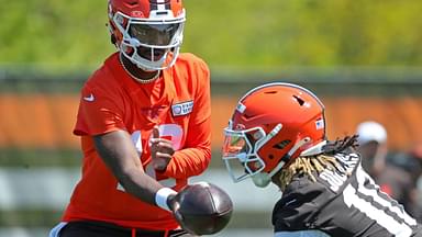 Cleveland Browns quarterback Shedeur Sanders (12) hands the ball off to Cleveland Browns running back Quinshon Judkins (10) during day two of NFL rookie minicamp at the Cleveland Browns training facility on Saturday, May 10, 2025, in Berea, Ohio.