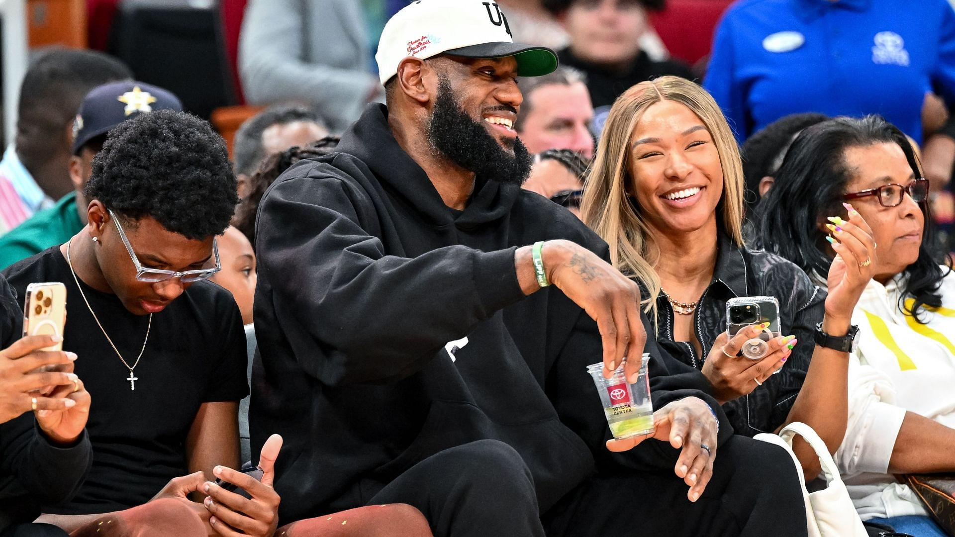 Los Angeles Laker LeBron James and his wife Savannah James sit court side at the McDonald's All American game during the first half at Toyota Center.
