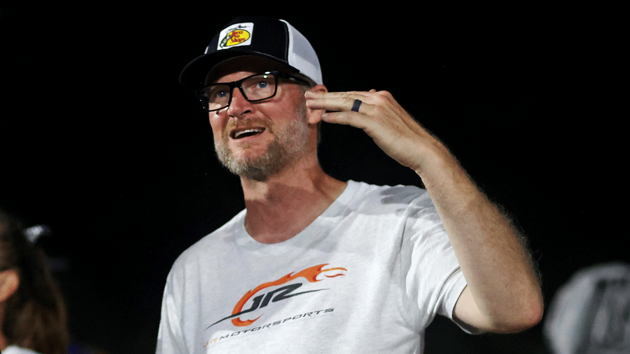 Jul 20, 2024; Hampton, VA, USA; Dale Earnhardt Jr. talks with late model drive Ryley Music before qualifying for the 16th Annual Hampton Heat at Langley Speedway. Mandatory Credit: Peter Casey-Imagn Images