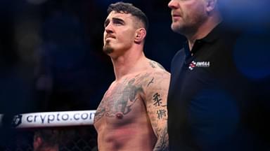 om Aspinall (red gloves) reacts to defeating Marcin Tybura (blue gloves) during UFC Fight Night at O2 Arena