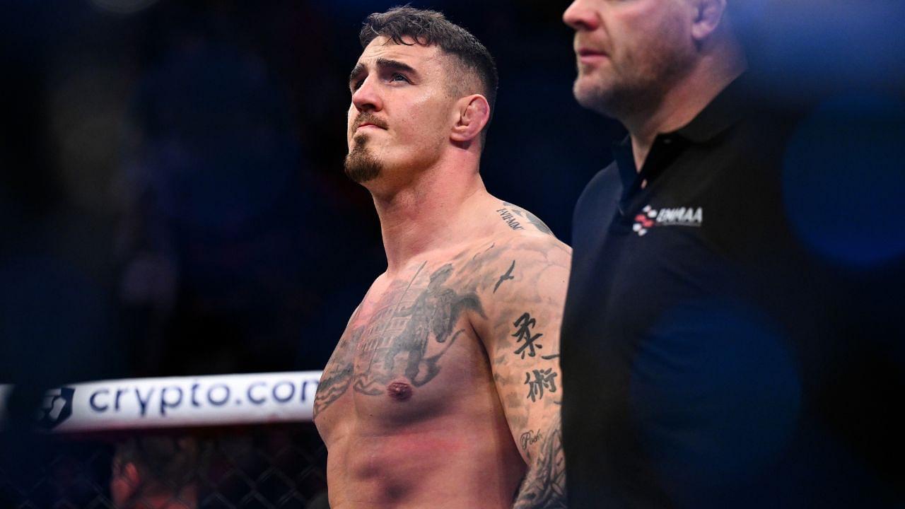 om Aspinall (red gloves) reacts to defeating Marcin Tybura (blue gloves) during UFC Fight Night at O2 Arena