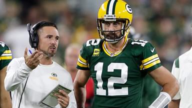 Green Bay Packers head coach Matt LaFleur talks with quarterback Aaron Rodgers (12) in between quarters against the Chicago Bears during their game on Sep 18, 2022, in Green Bay, Wisconsin.