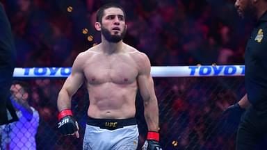 Islam Makhachev (red gloves) reacts after defeating Renato Moicano (blue gloves) in a lightweight title fight during UFC 311 at Intuit Dome.