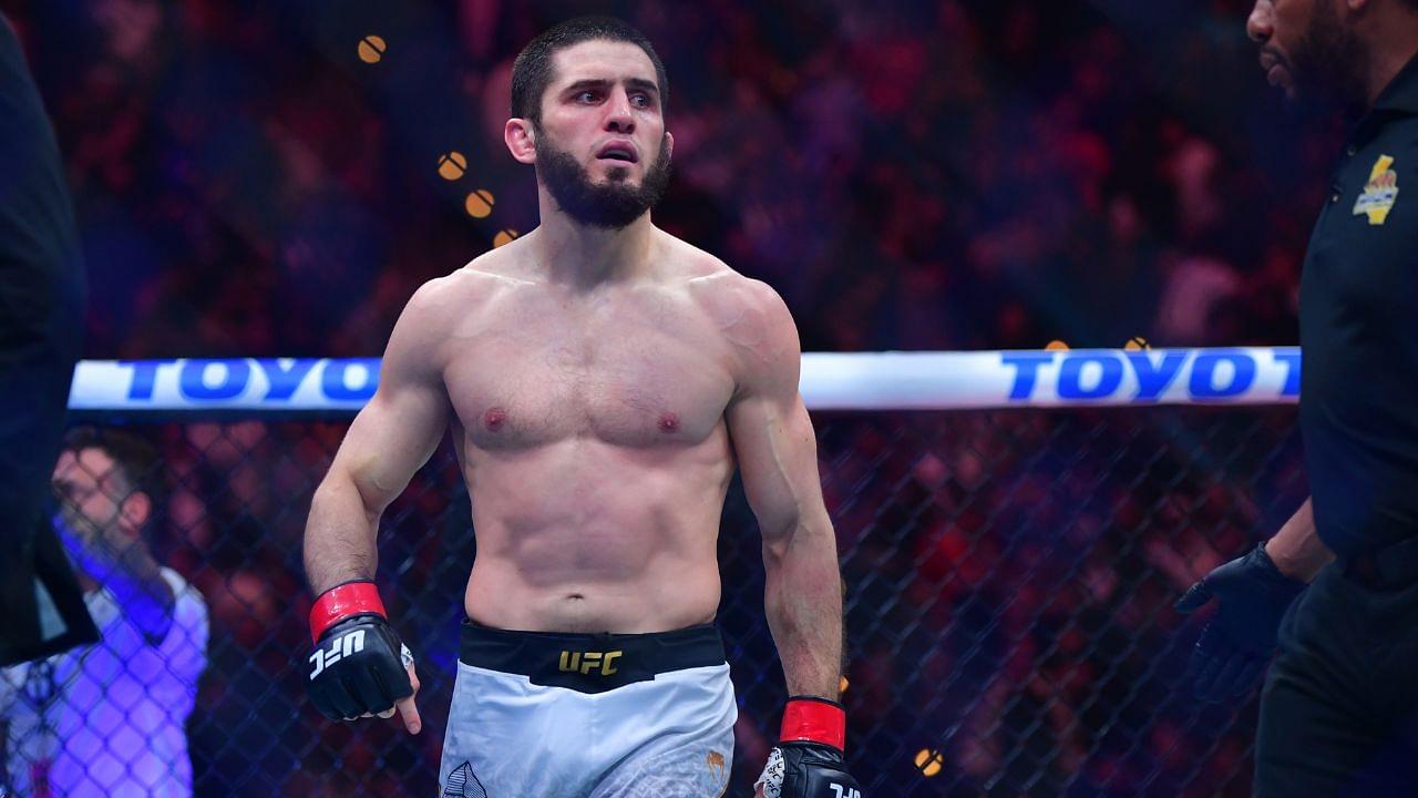 Islam Makhachev (red gloves) reacts after defeating Renato Moicano (blue gloves) in a lightweight title fight during UFC 311 at Intuit Dome.
