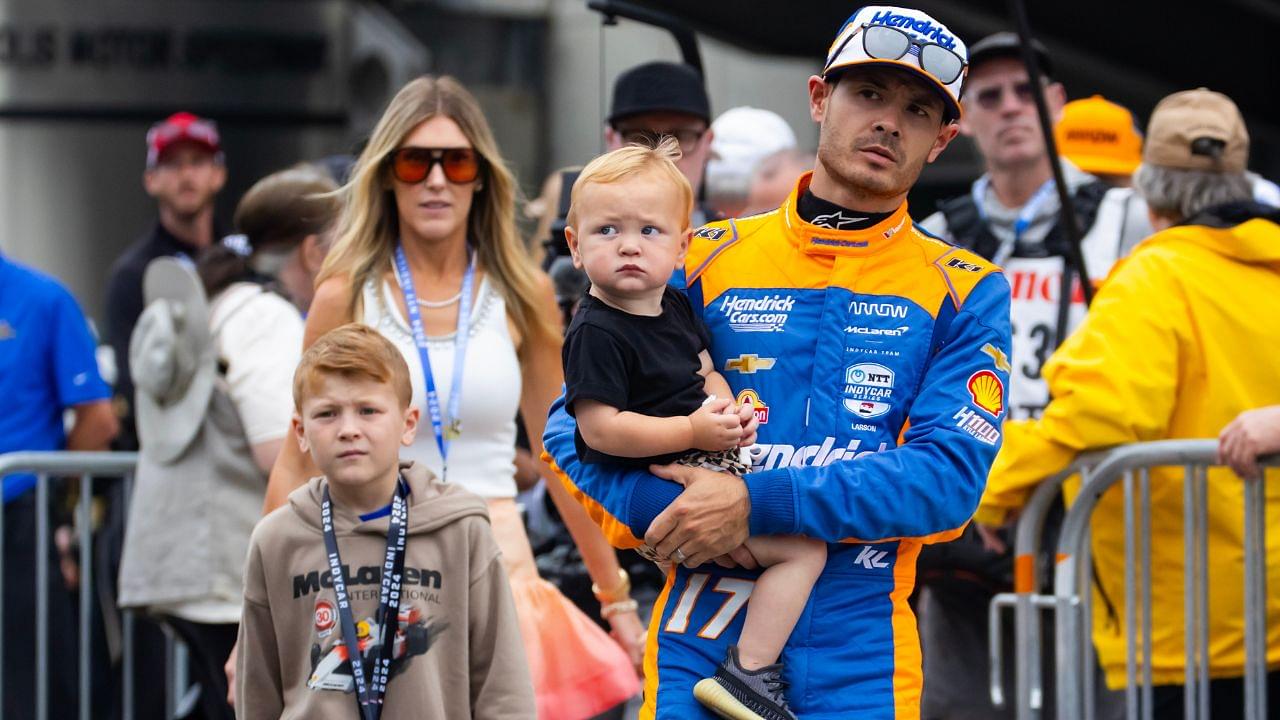 Indycar Series driver Kyle Larson holds son Cooper Larson as he walks with wife Katelyn Larson and son Owen Larson prior to the 108th running of the Indianapolis 500 at Indianapolis Motor Speedway.
