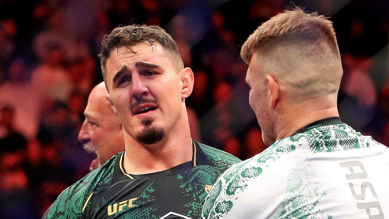 Tom Aspinall (blue gloves) reacts to beating Sergei Pavlovich (red gloves) during UFC 295 at Madison Square Garden.