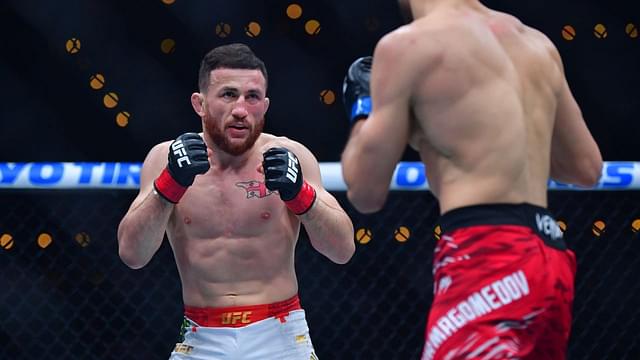 Merab Dvalishvili (red gloves) fights Umar Nurmagomedov (blue gloves) during UFC 311 at Intuit Dome.