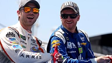 Dale Earnhardt Jr. talks with NASCAR Cup Series driver Daniel Suarez (19) before the Toyota Owners 400 at Richmond International Raceway.